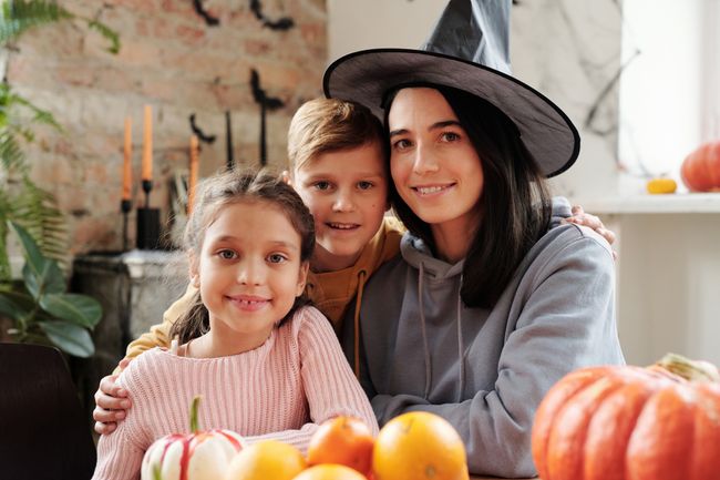 A mom with her children celebrating Halloween together