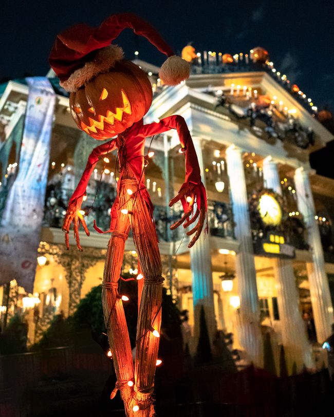 House decorated with glowing Halloween lights and spooky decorations