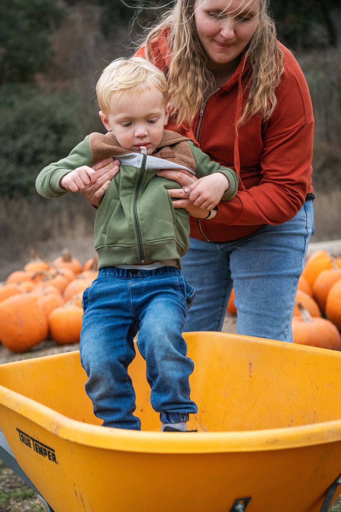 A mother and child making memories at a pumpkin patch