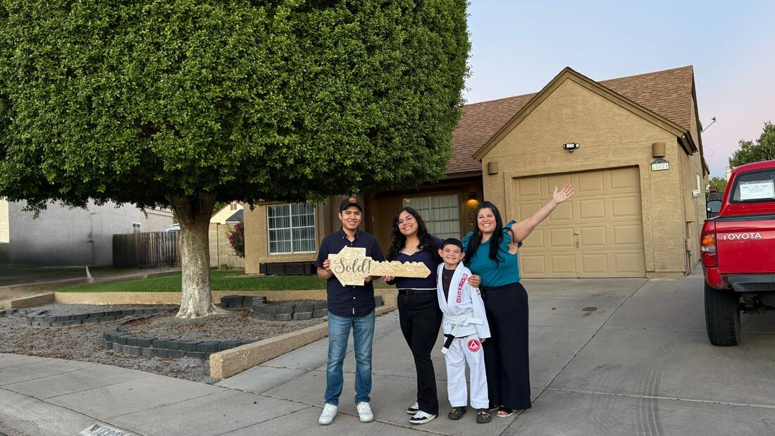 A family celebrating a home milestone